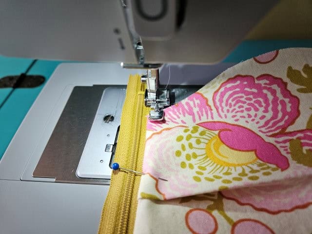 Top stitch along the zipper