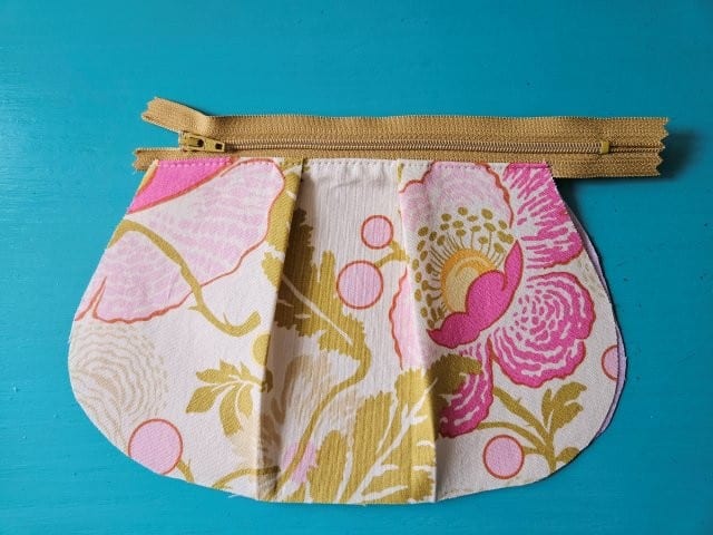 One side of the zipper attached to the pouch