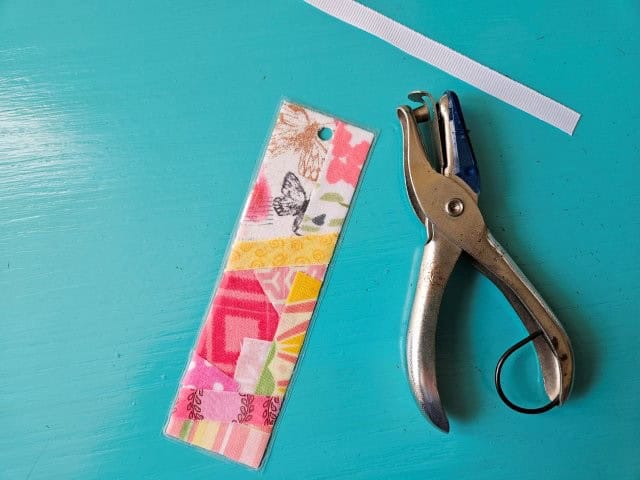 Punch a hole in the top of the bookmark