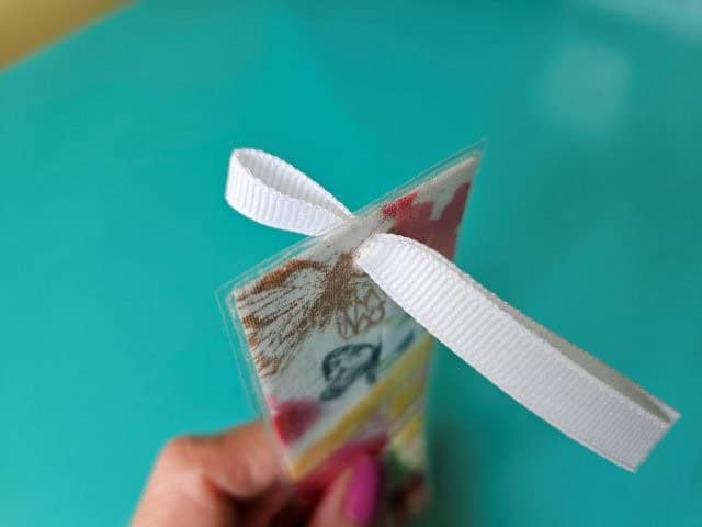 Fold the ribbon in half and slip through the hole in the bookmark