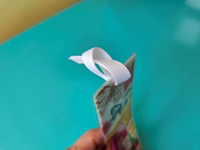Place the ribbon ends through the loop
