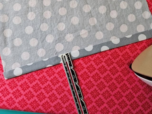 Hem the top edge of the fabric