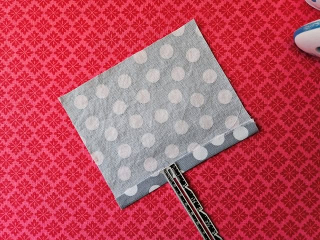 Hem the bottom of the small fabric pieces