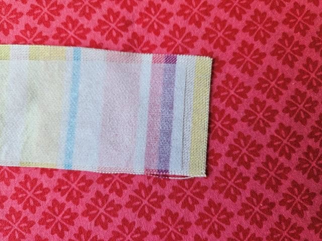 Interfacing shorter than strap for hemming
