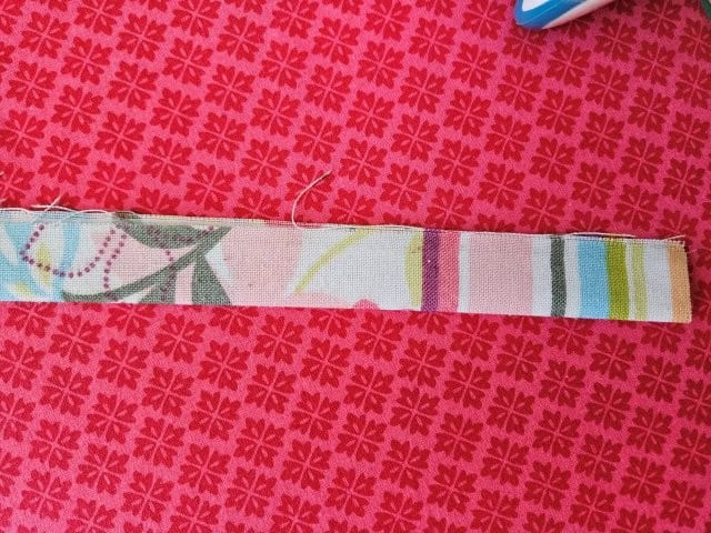 Fold the strap in half lengthwise