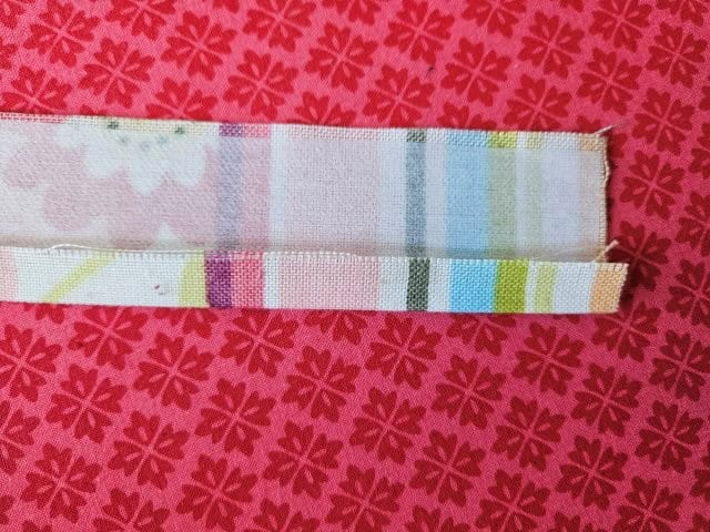Open up strap and fold to center