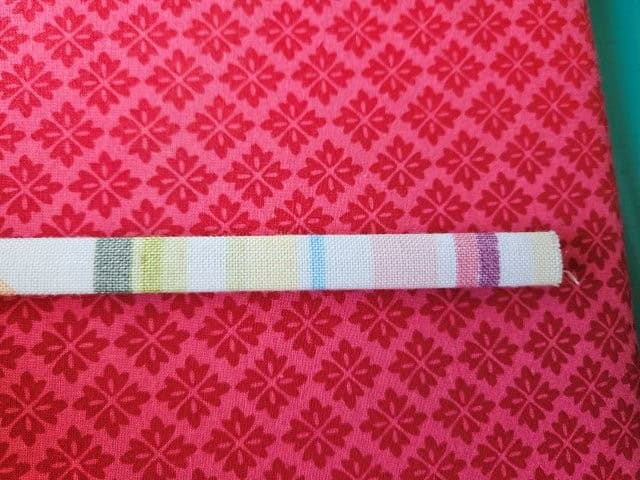 Fold the strap in half again and press