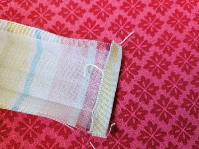 Fold the end of the strap to hem