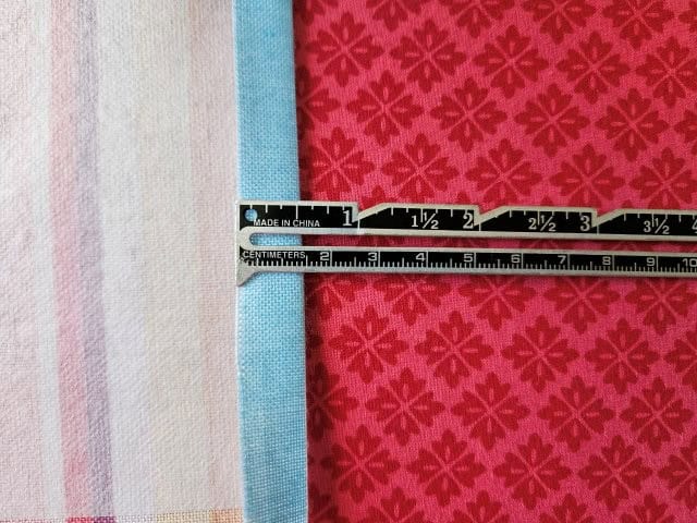 Fold over the top of one of the lining pieces 1/2"