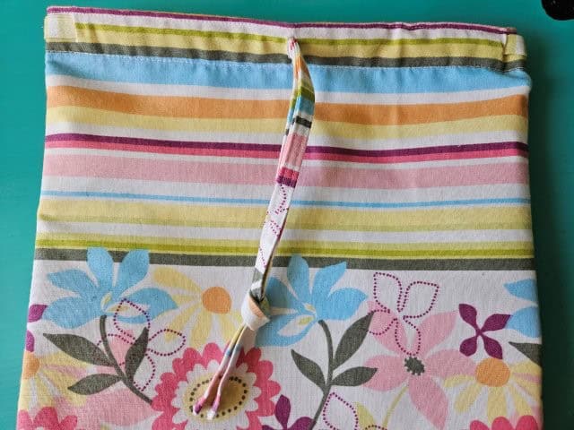 Tie a knot in the straps in the front of the backpack