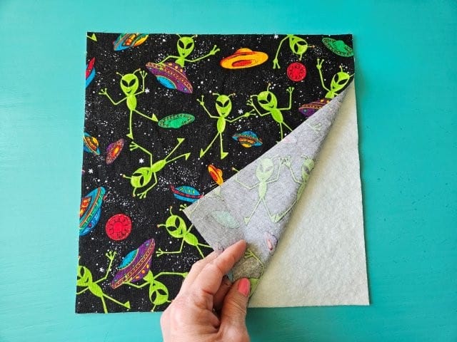 Add batting to the wrong side of the outer fabric pieces