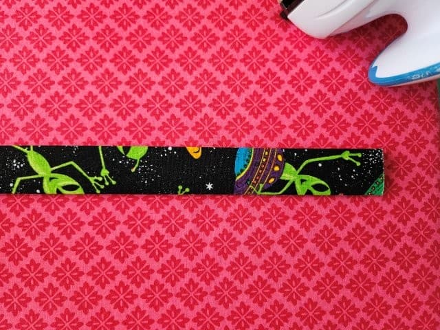 Fold the strap in half again and press