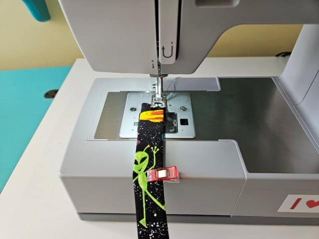 Sew the strap lengthwise on both sides of the strap