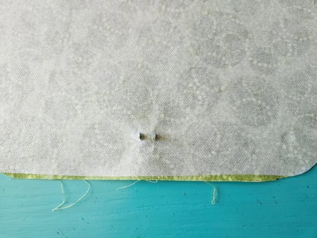 Push the prongs through the slits