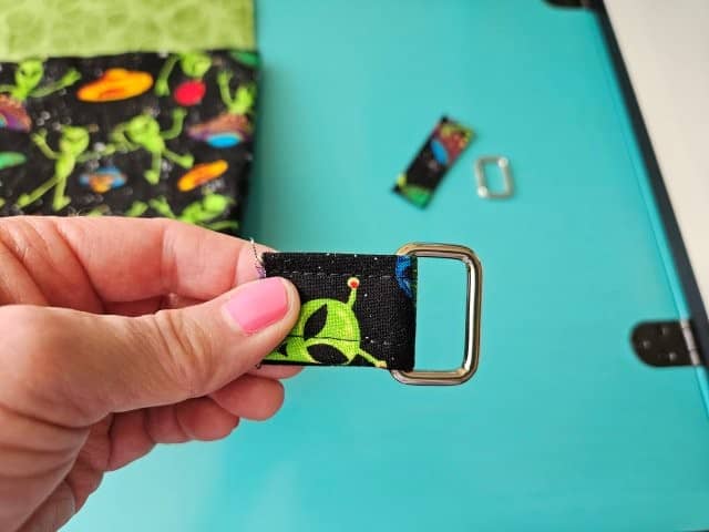 Slide the strap through the rectangle ring and fold over