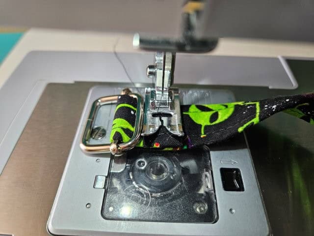 Sew to attach the strap to the slide