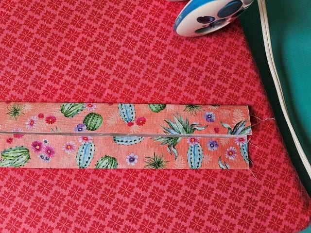 Turn the strap around and fold the other side to center