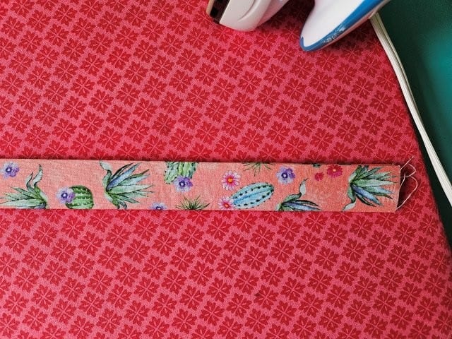 Fold the strap in half again and press