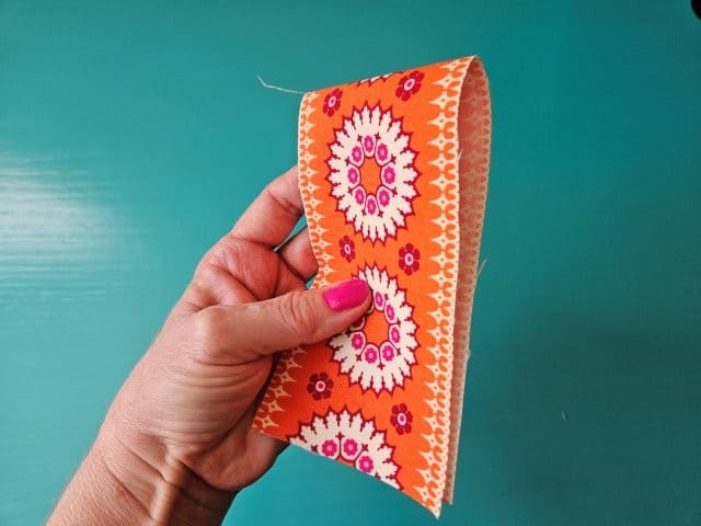 Fold pocket piece in half with short sides touching