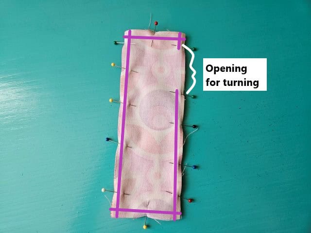 Pin around the bookmark to hold in place leaving and opening for turning