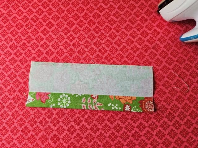 Open back up and fold the strap to the center