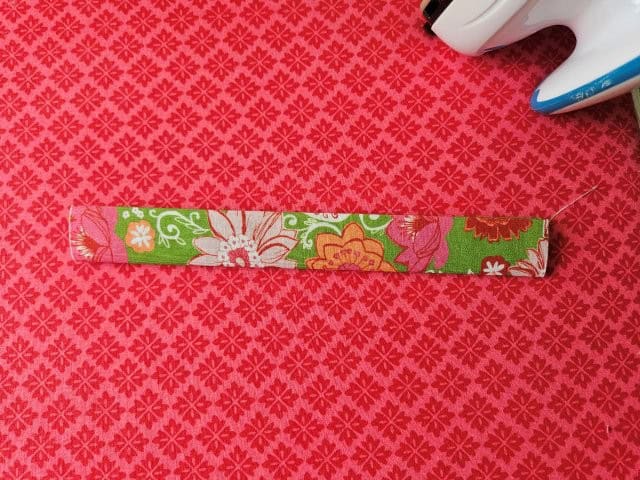 Fold the strap in half again