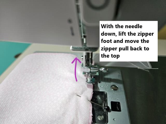 Lift zipper foot and move zipper pull back to the top