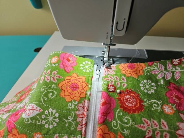 Top stitch along the zipper