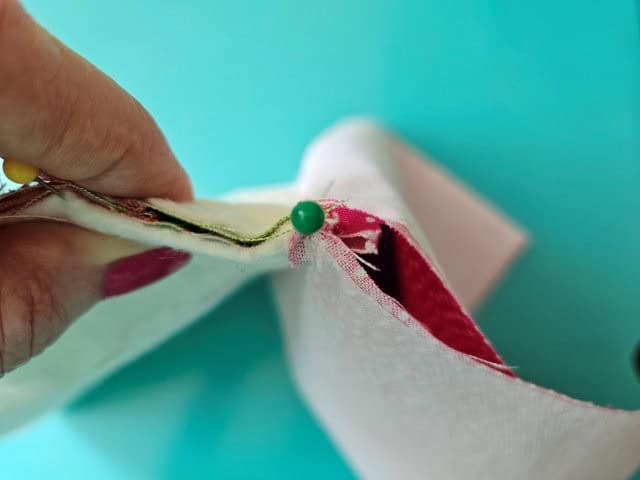 Pinch the zipper with teeth towards the lining and pin