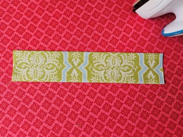 Fold each long edge to the center and press