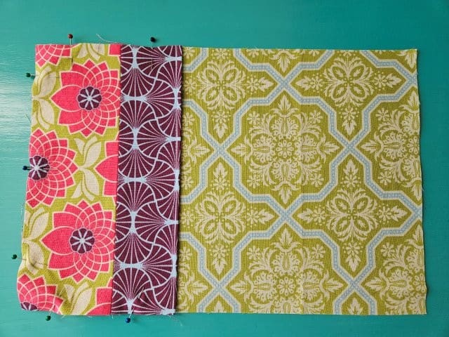 Pin the raw edges of the pocket to hold in place