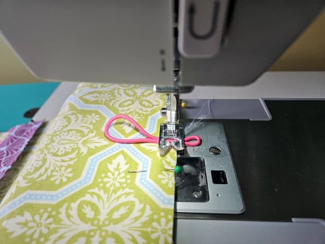 Baste the hair tie to the lining piece