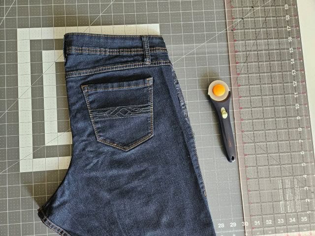 Fold the jeans in half wrong sides together