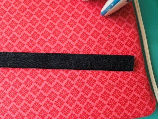 Fold the strap in half again and press