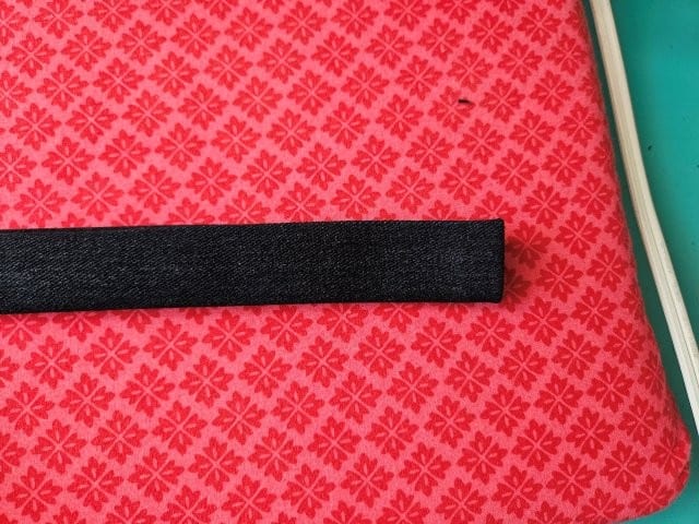 Fold the strap in half again and press