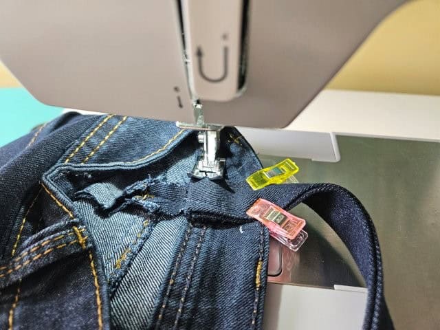 Sew the bottom of the strap to the bag