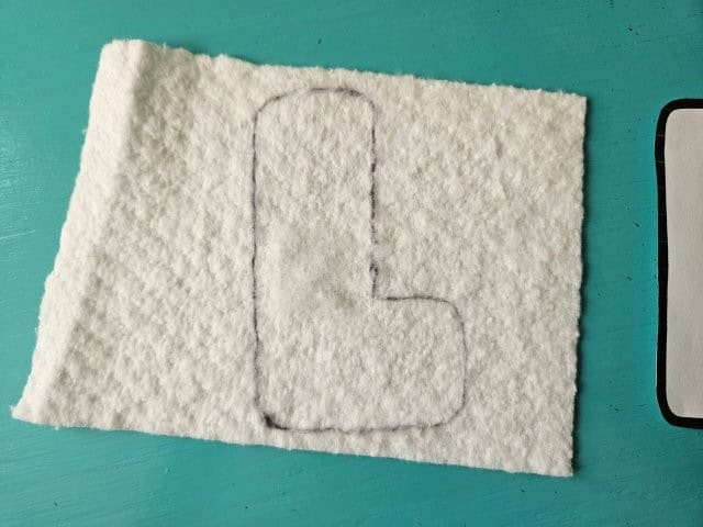 Trace the letters onto the cotton batting