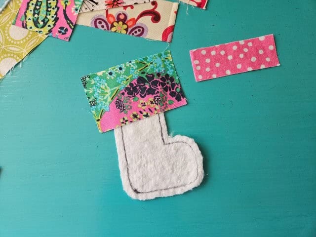 Place the fabric scrap right side up on batting