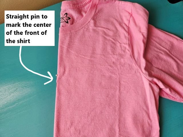 Fold the shirt in half to find the center on the front of the shirt