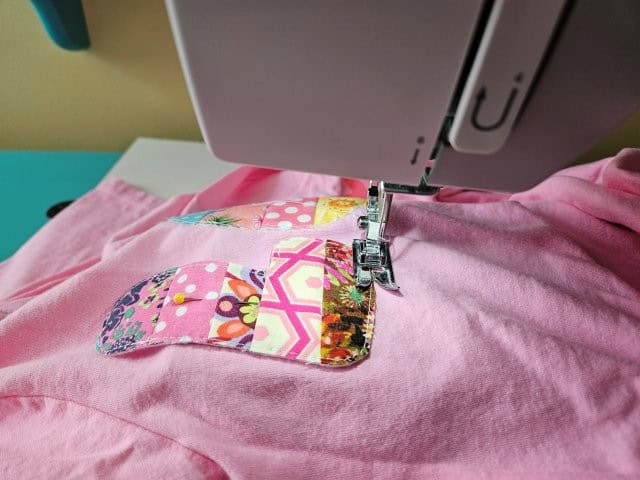 Sew the letters to the shirt using a narrow zigzag stitch