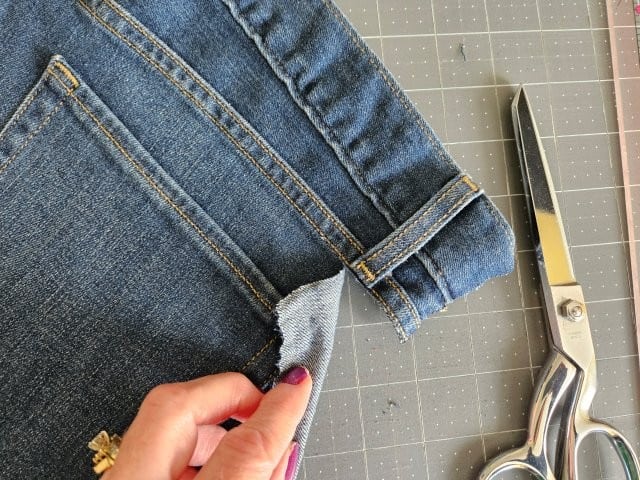 Cut along the stitching above the pocket