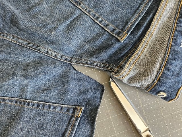 Cut along the stitching in the middle