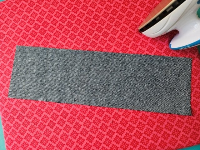 Place the wristlet strap right side down on ironing board