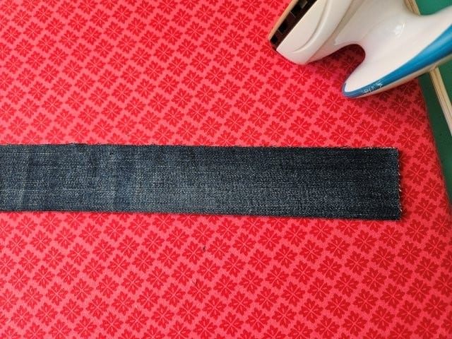 Fold the strap in half lengthwise and press