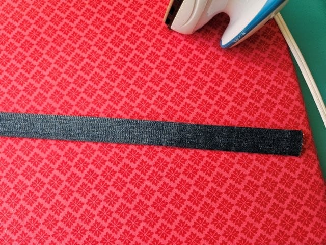 Fold the strap in half again and press