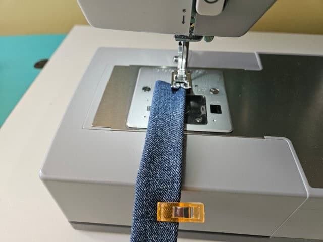 Sew along each folded edge of the strap