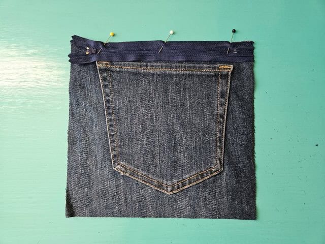 Place zipper face down on front fabric