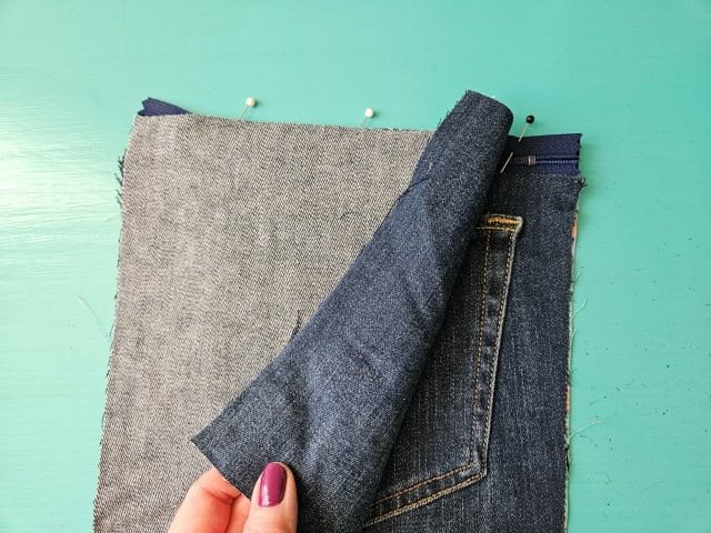 Place the other outer denim piece on top of the zipper