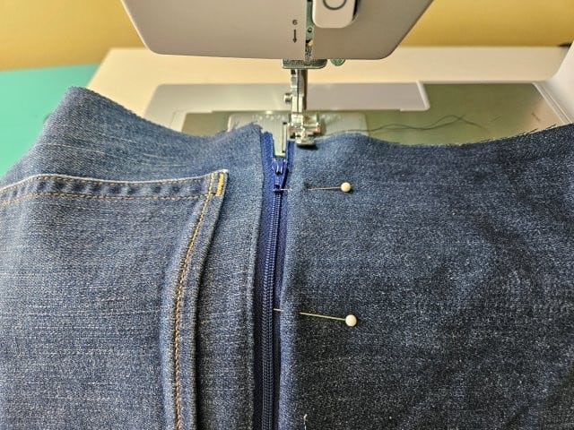 Top stitch along the zipper