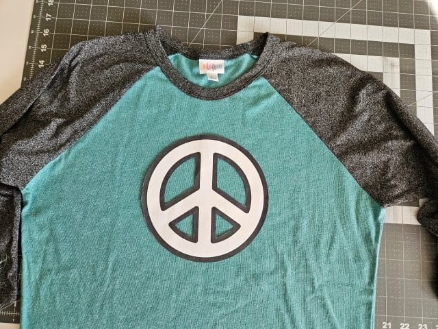 Place the peace sign on the shirt for placement